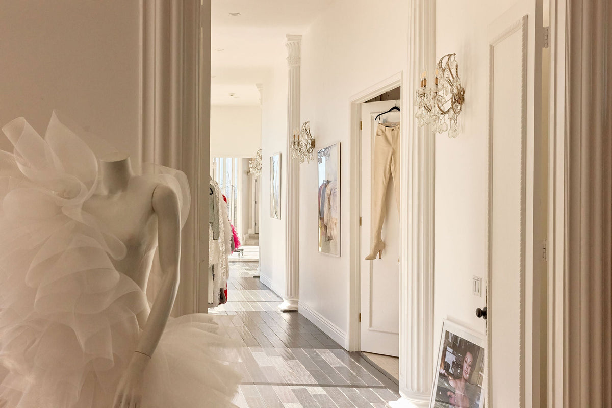 Elegant bridal gown displayed in a boutique hallway during a private bridal appointment